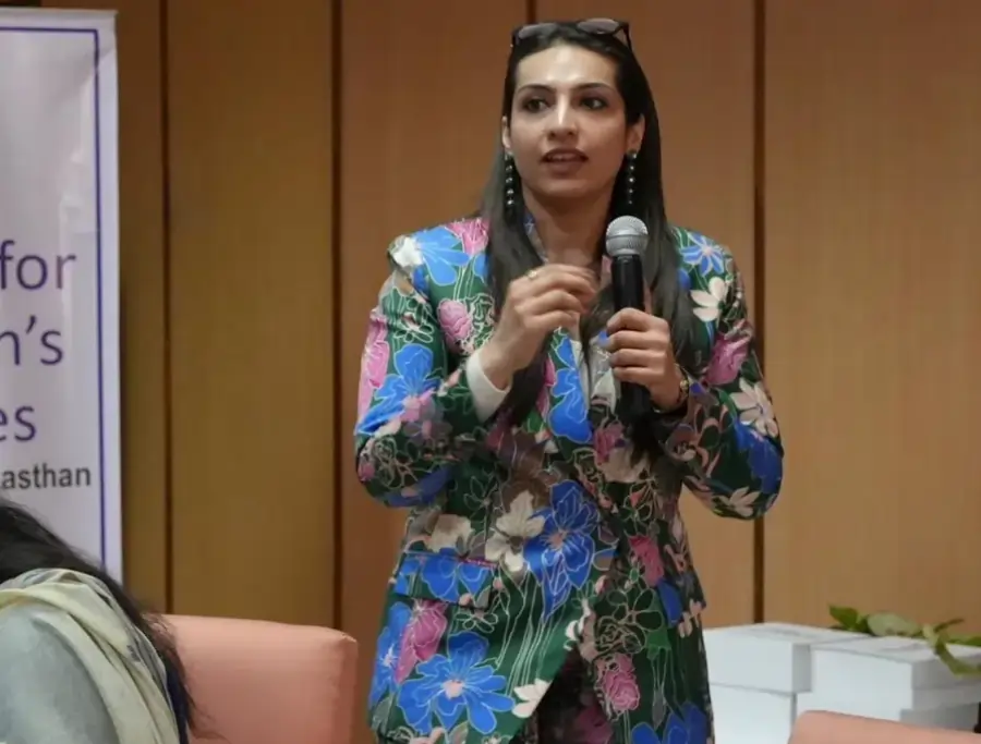 Woman standing beside Avyya V-Bliss product display