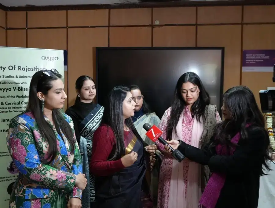 Two women standing beside Avyya V-Bliss product display